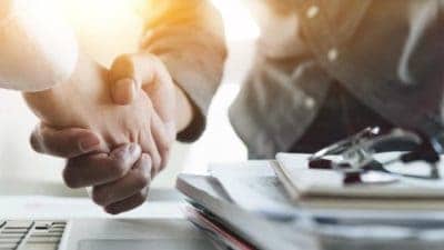 Hands shaking over a business deal