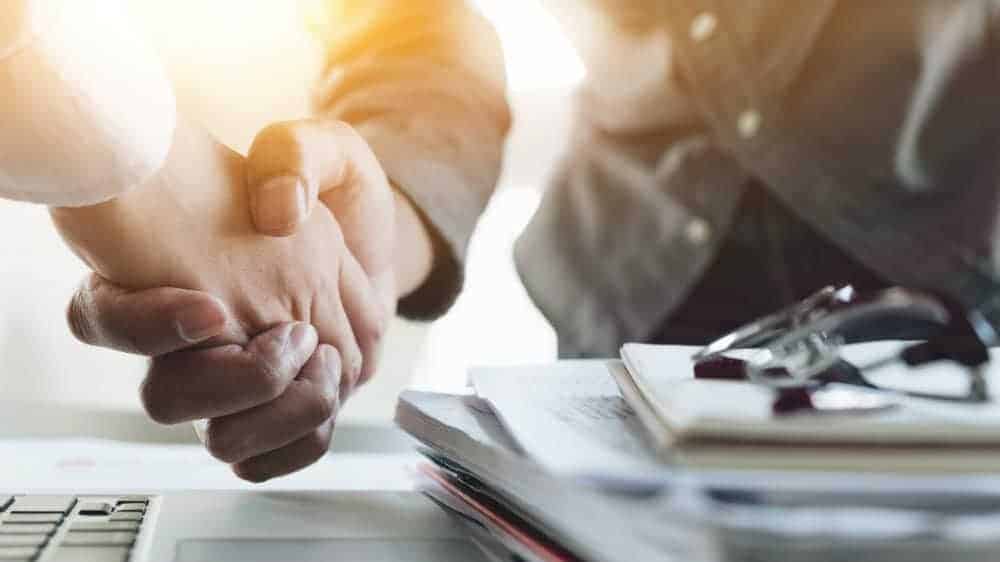 Hands shaking over a business deal