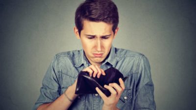 Man with no money. Businessman holding empty wallet