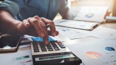 edit Business accounting concept, Business man using calculator with computer laptop, budget and loan paper in office.