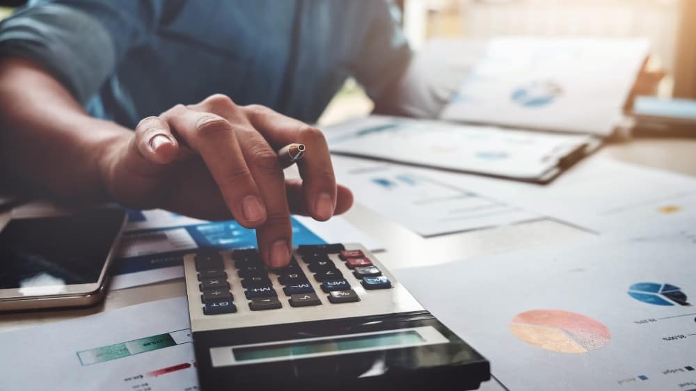 edit Business accounting concept, Business man using calculator with computer laptop, budget and loan paper in office.