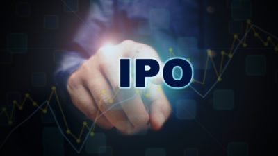 Close up finger pointing into the ipo text with initial public offering concept.
