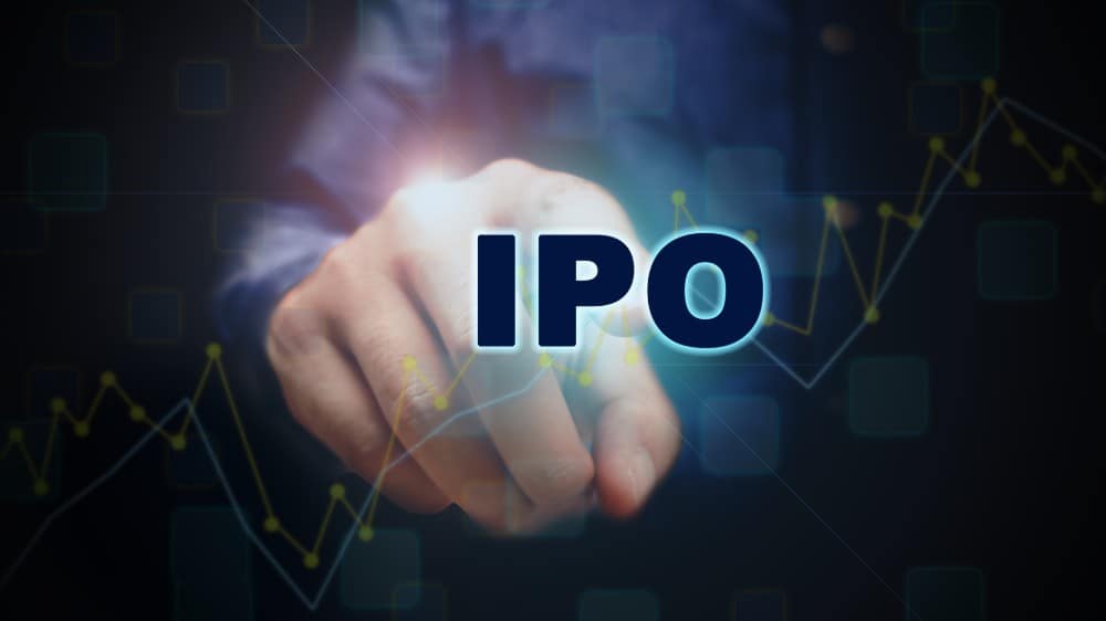 Close up finger pointing into the ipo text with initial public offering concept.