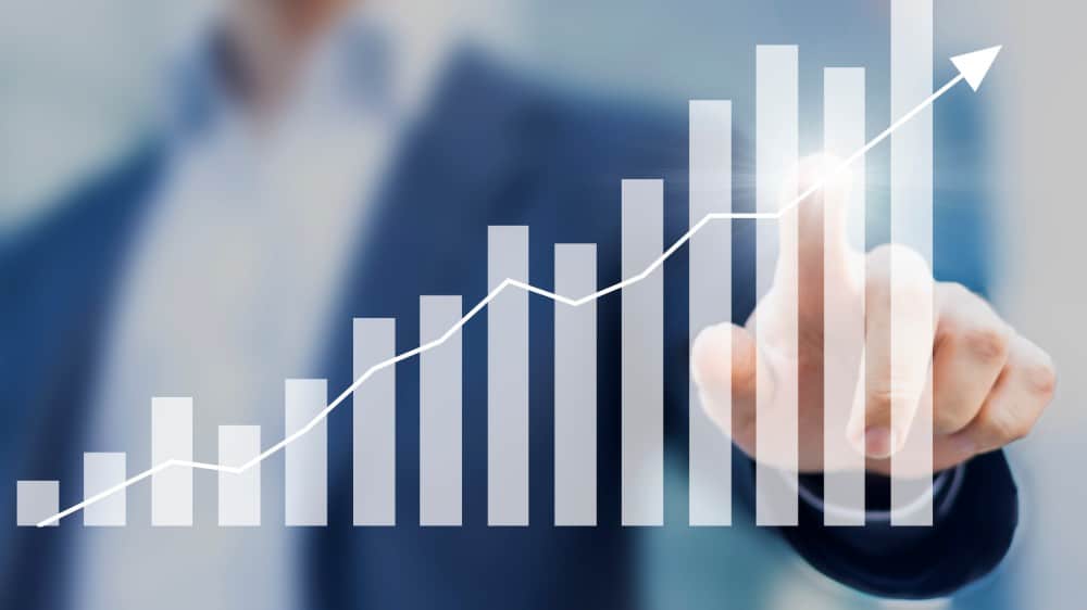 Business success with growing, rising charts and businessman in background
