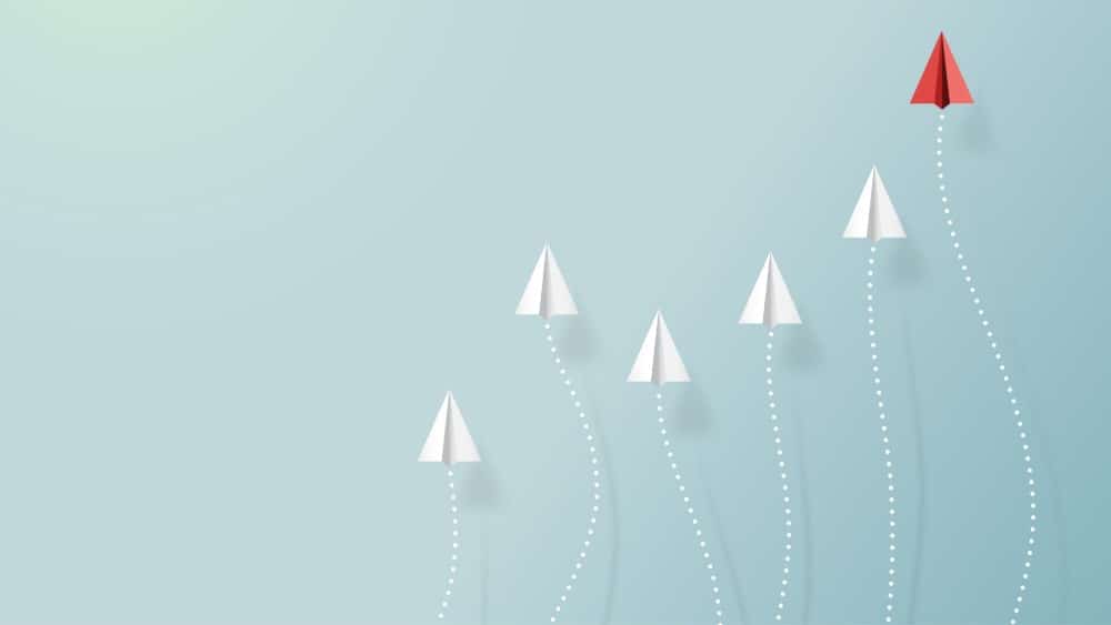 Paper airplanes flying on blue sky with form of growing graph