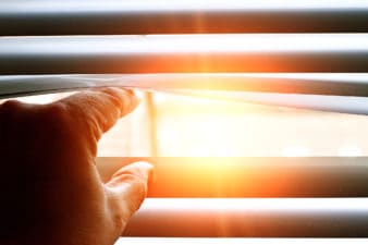 Light shines through a crack in a window covering